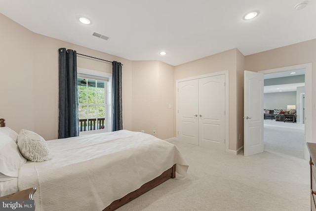 bedroom with light colored carpet, recessed lighting, baseboards, visible vents, and a closet