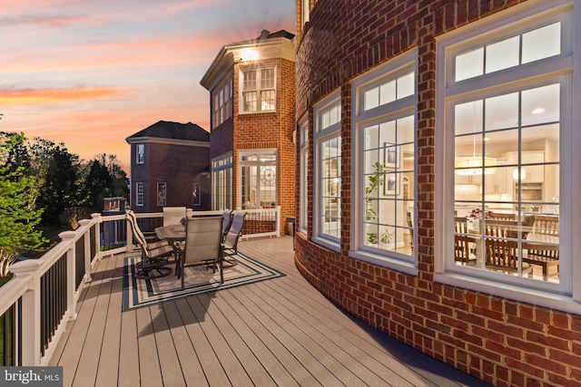 wooden terrace featuring outdoor dining area
