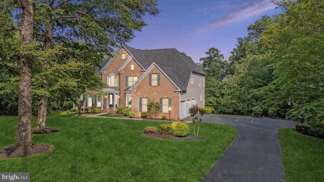 8810 Primula Dr, Laytonsville, MD 20882 - view of front of home with driveway, brick siding, a front lawn, and roof with shingles