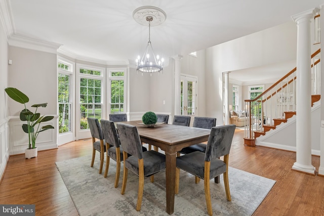 8810 Primula Dr, Laytonsville, MD 20882 - dining area with a chandelier, light wood finished floors, stairway, crown molding, and ornate columns