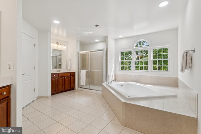 8810 Primula Dr, Laytonsville, MD 20882 - bathroom with vanity, a shower stall, a garden tub, recessed lighting, and tile patterned flooring