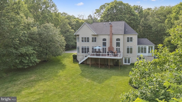 8810 Primula Dr, Laytonsville, MD 20882 - back of property featuring a deck, a yard, roof with shingles, and a chimney
