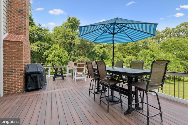 8810 Primula Dr, Laytonsville, MD 20882 - wooden deck featuring outdoor dining area, area for grilling, and view of wooded area