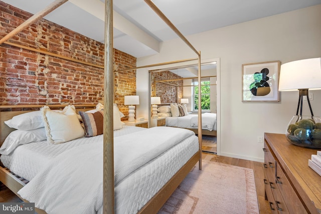 1224 11th St NW Unit 3, Washington, DC 20001 - bedroom with baseboards, wood finished floors, brick wall, and a closet