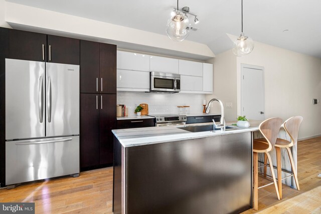 1224 11th St NW Unit 3, Washington, DC 20001 - kitchen with white cabinets, appliances with stainless steel finishes, a sink, and light countertops