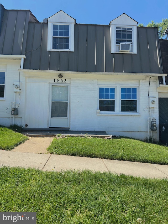 1852 Village Green Dr Unit E-122, Landover, MD 20785 - view of front of house featuring brick siding, metal roof, and a standing seam roof