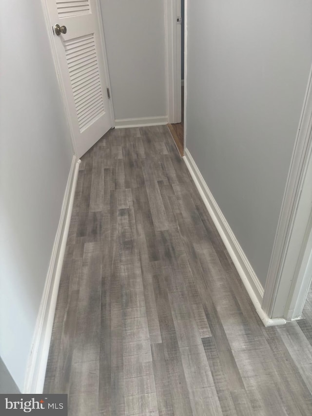 1852 Village Green Dr Unit E-122, Landover, MD 20785 - hallway featuring baseboards and dark wood-style floors