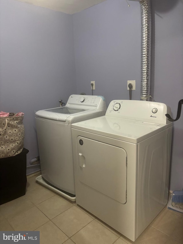 1852 Village Green Dr Unit E-122, Landover, MD 20785 - laundry area with light tile patterned floors, laundry area, and washer and clothes dryer