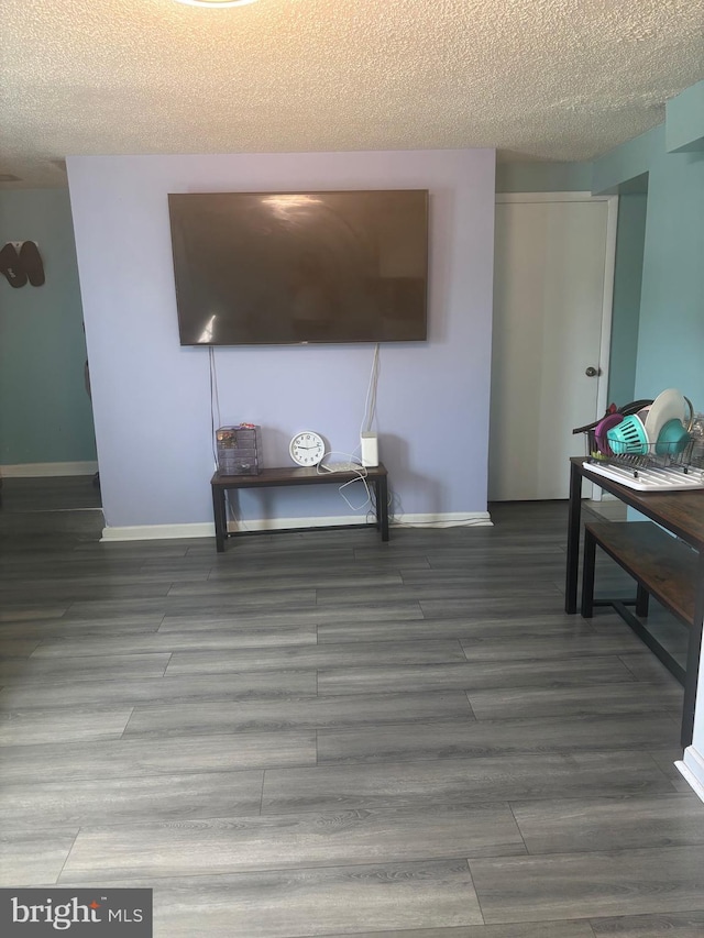 1852 Village Green Dr Unit E-122, Landover, MD 20785 - living area featuring baseboards, a textured ceiling, and wood finished floors