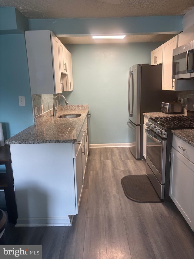 1852 Village Green Dr Unit E-122, Landover, MD 20785 - kitchen featuring a sink, dark stone countertops, appliances with stainless steel finishes, and tasteful backsplash