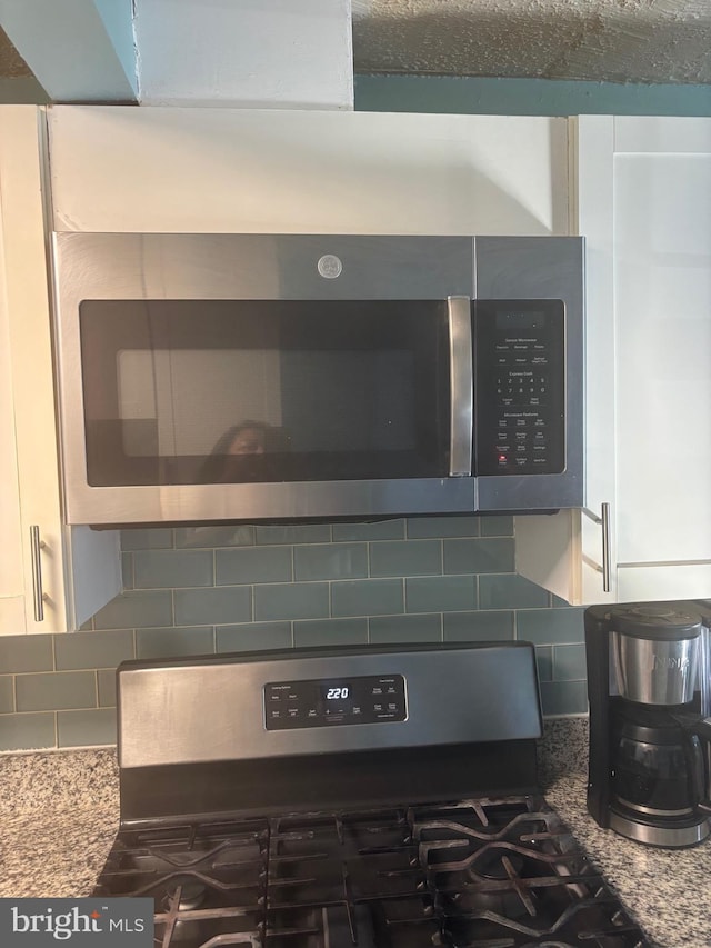 1852 Village Green Dr Unit E-122, Landover, MD 20785 - room details featuring white cabinetry, tasteful backsplash, and stainless steel appliances