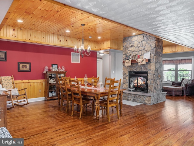 1996 Buck Mountain Rd, Bentonville, VA 22610 - dining space with hardwood / wood-style flooring, wood ceiling, a chandelier, a fireplace, and a wainscoted wall