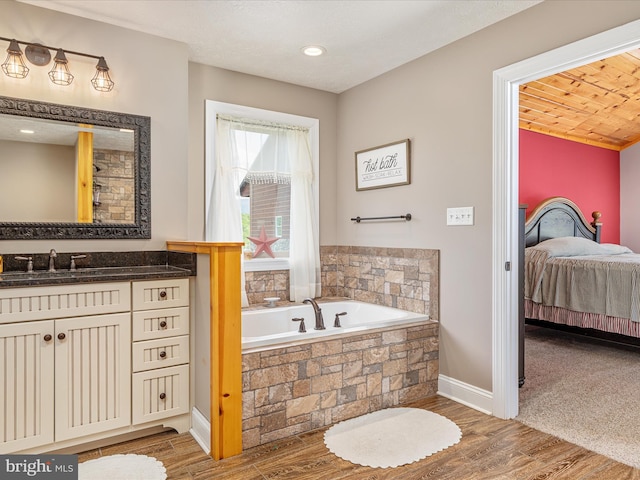 1996 Buck Mountain Rd, Bentonville, VA 22610 - bathroom with a garden tub, baseboards, vanity, and wood finished floors