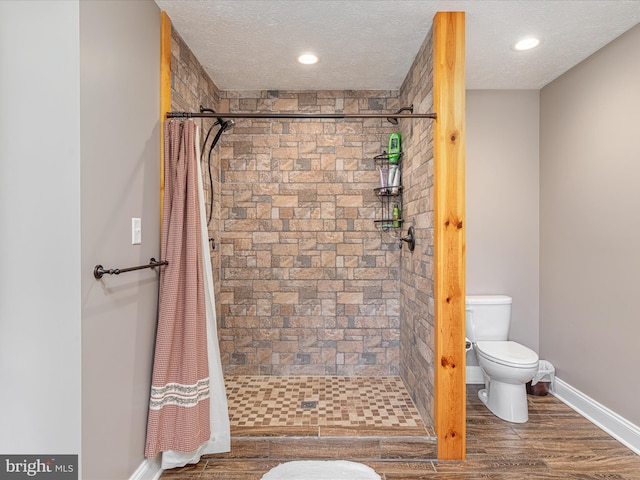 1996 Buck Mountain Rd, Bentonville, VA 22610 - full bath with a stall shower, toilet, a textured ceiling, baseboards, and wood finished floors