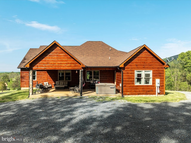 1996 Buck Mountain Rd, Bentonville, VA 22610 - rear view of house with a hot tub, an outdoor living space, a patio area, and a shingled roof