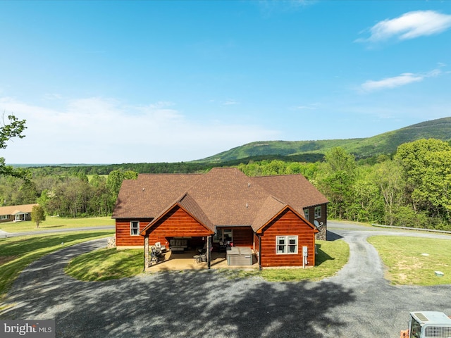 1996 Buck Mountain Rd, Bentonville, VA 22610 - view of front of home with a mountain view, driveway, a front lawn, and a shingled roof