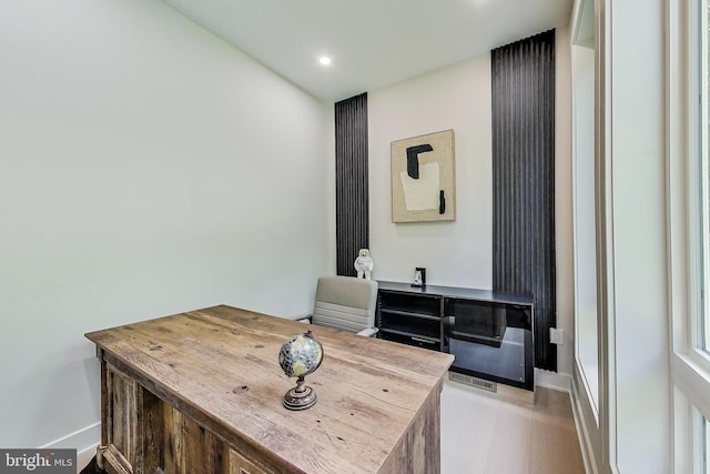 interior space with baseboards, recessed lighting, and wood finished floors