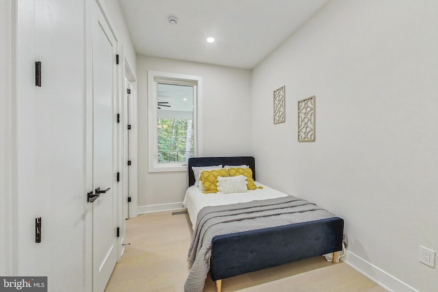 bedroom with recessed lighting, baseboards, and light wood-style flooring