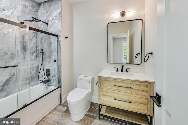 full bathroom with vanity, combined bath / shower with glass door, and toilet