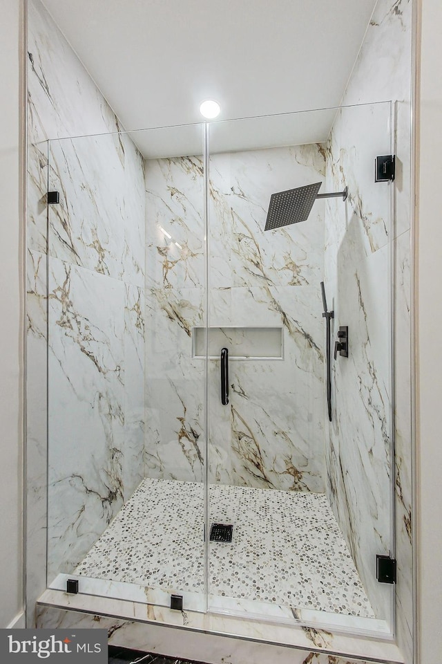 full bath with a marble finish shower