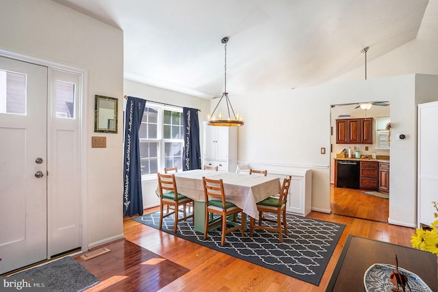 dining area featuring visible vents, light wood finished floors, and lofted ceiling