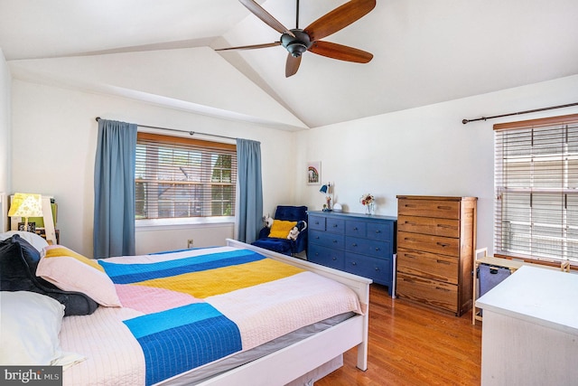 bedroom with a ceiling fan, lofted ceiling, and light wood-type flooring