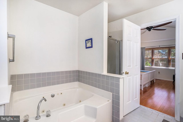 full bathroom featuring tile patterned floors, ceiling fan, a stall shower, and a tub with jets