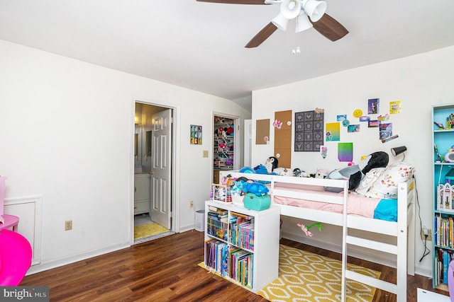 bedroom featuring ensuite bathroom, a ceiling fan, baseboards, and wood finished floors