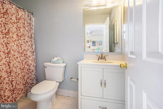 full bath with tile patterned floors, vanity, toilet, and curtained shower