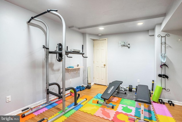 workout area with recessed lighting, baseboards, and wood finished floors