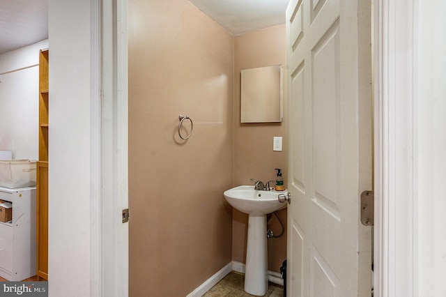 half bathroom featuring baseboards