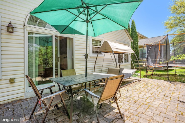 view of patio / terrace with outdoor dining area and a trampoline
