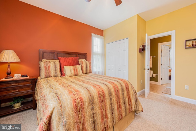 bedroom with light colored carpet, baseboards, a ceiling fan, and a closet