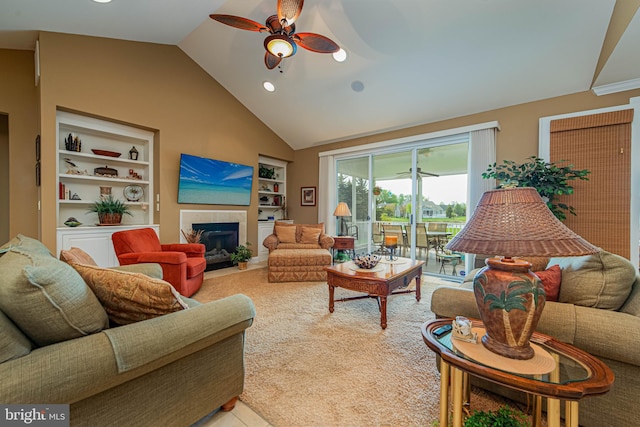 living room with a fireplace with flush hearth, ceiling fan, recessed lighting, and built in shelves