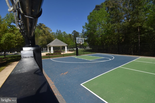 view of sport court with fence, a gazebo, and community basketball court