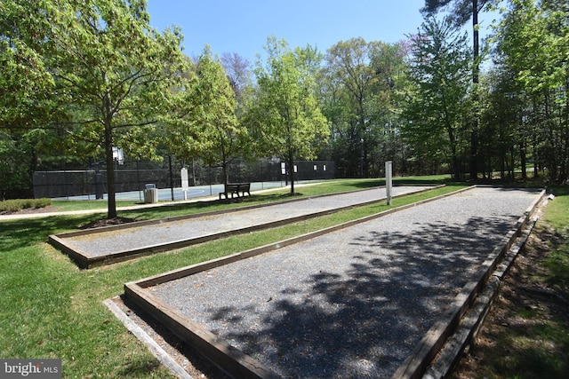 view of community with a yard and fence