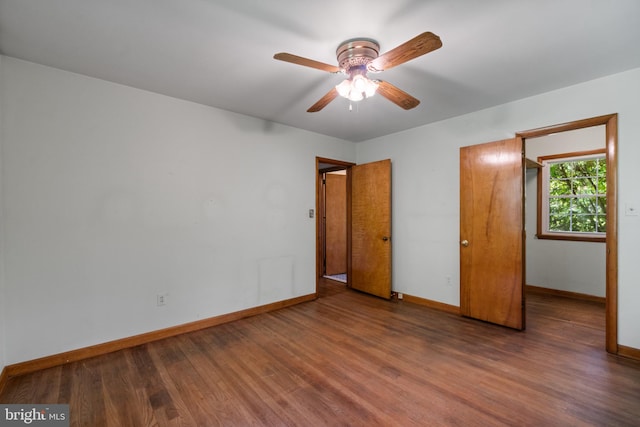 unfurnished bedroom with baseboards, wood finished floors, and ceiling fan