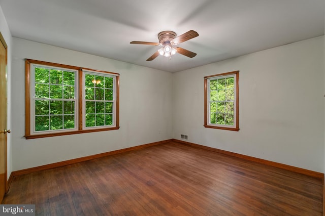 unfurnished room featuring wood-type flooring, baseboards, and ceiling fan