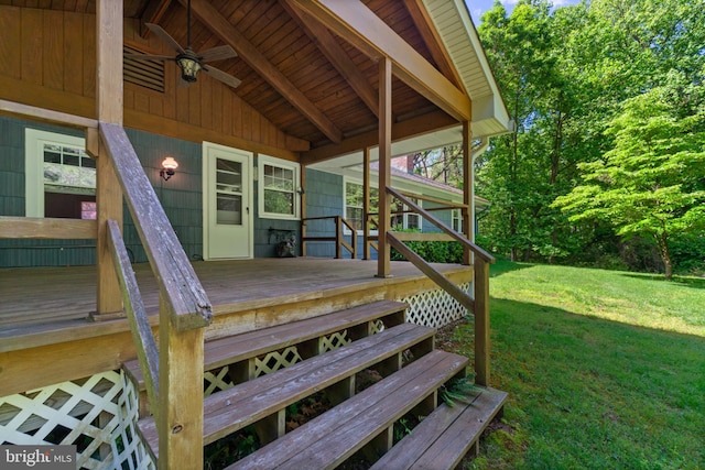 wooden deck featuring a lawn and a ceiling fan