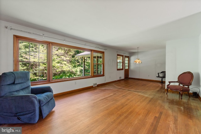 sitting room with light wood-style flooring and baseboards