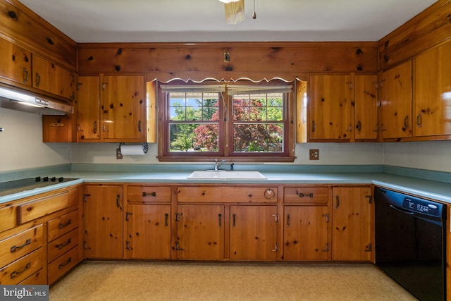 kitchen featuring black appliances, a sink, light countertops, under cabinet range hood, and brown cabinets