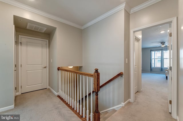 hallway with carpet floors, baseboards, an upstairs landing, and visible vents
