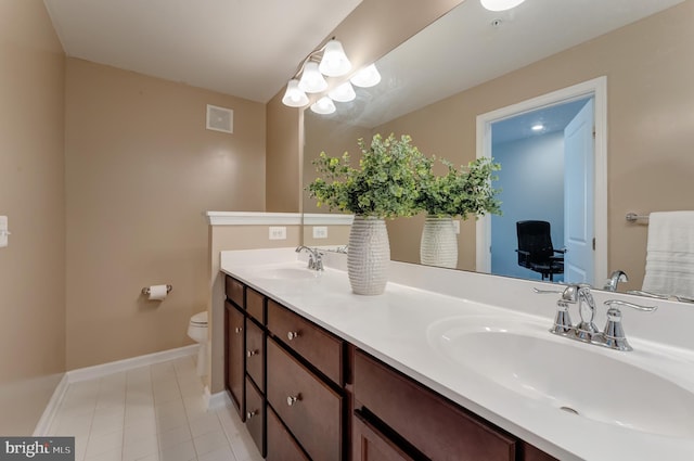 bathroom with a sink, toilet, double vanity, and visible vents