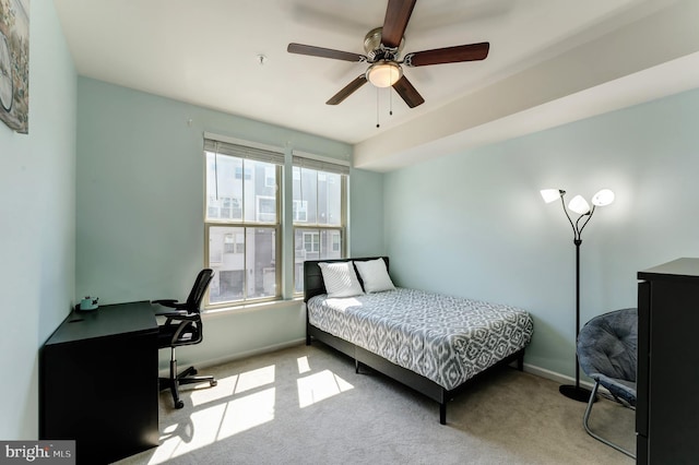 carpeted bedroom featuring baseboards and ceiling fan