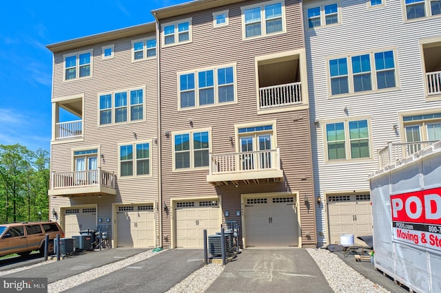 view of property featuring driveway and a garage