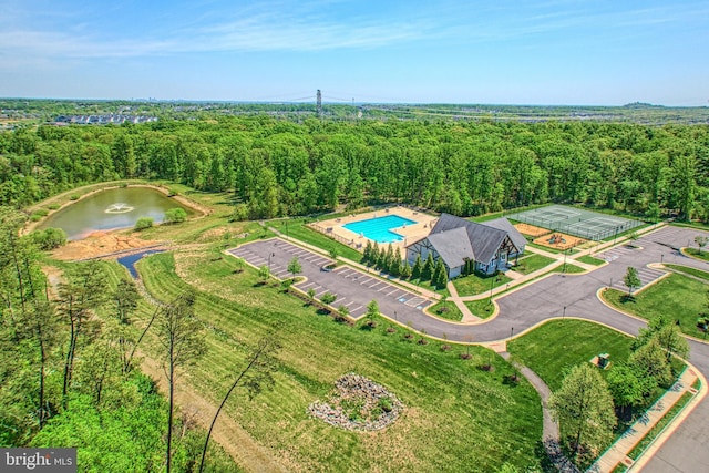 birds eye view of property with a water view and a forest view