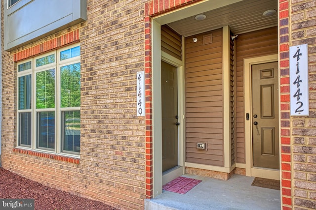 entrance to property with brick siding