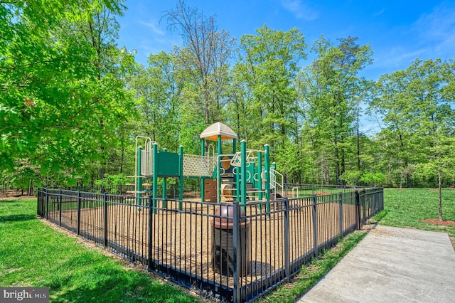 communal playground with fence and a yard