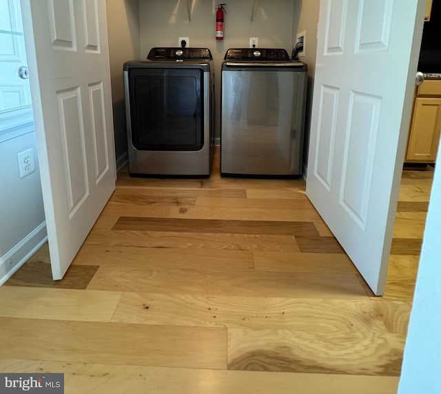 42429 Rockrose Sq, Brambleton, VA 20148 - laundry room featuring washer and dryer and light wood-style floors