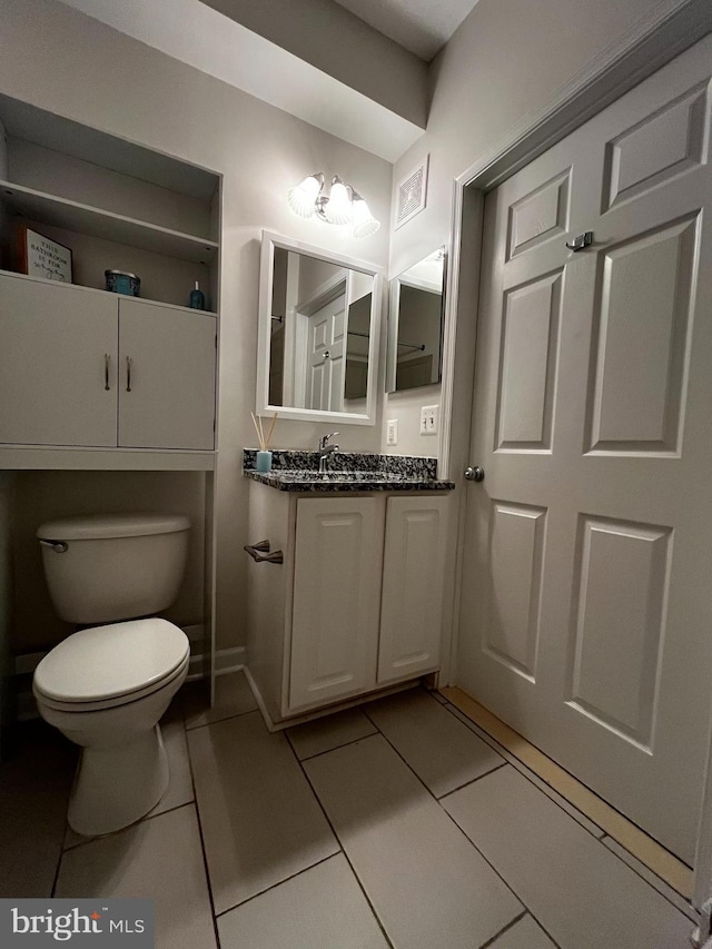42429 Rockrose Sq, Brambleton, VA 20148 - half bathroom featuring toilet, tile patterned floors, vanity, and baseboards